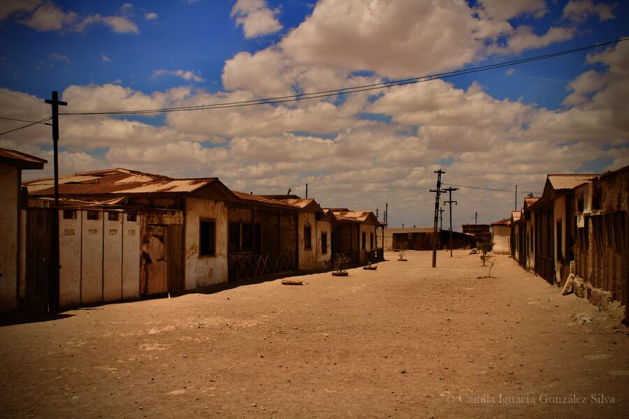 Street view in Humberstone with houses, utility poles, and desert sky